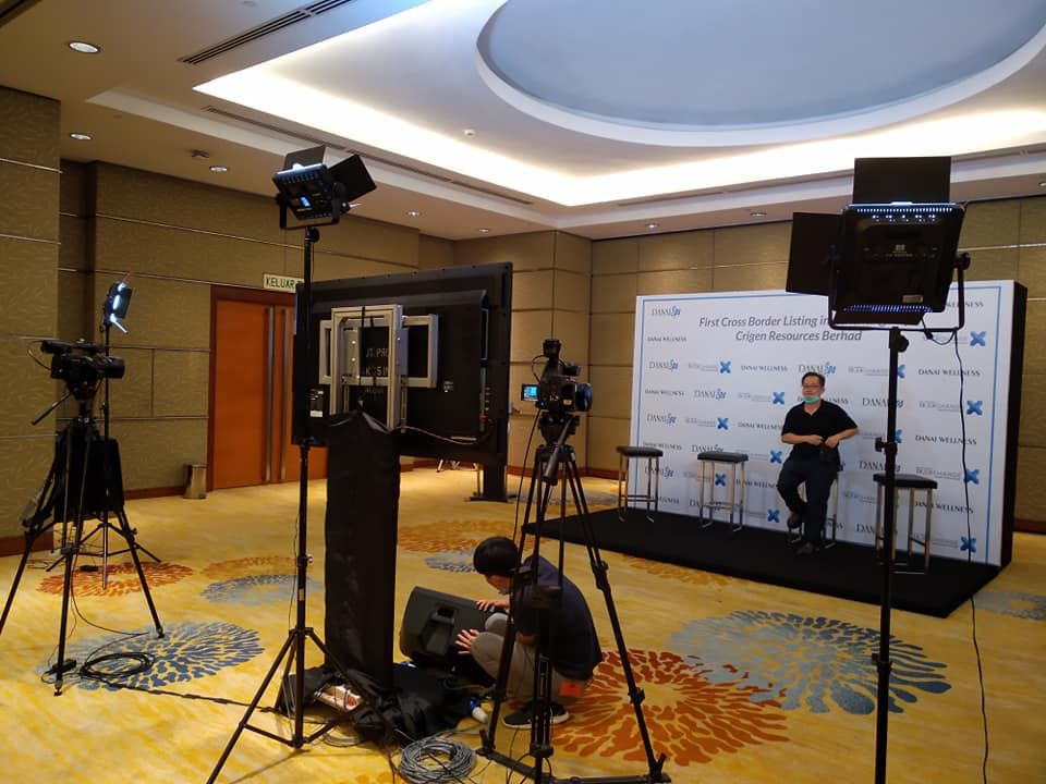 Stage backdrop with cameras, lighting and LED screen set up for an event livestream