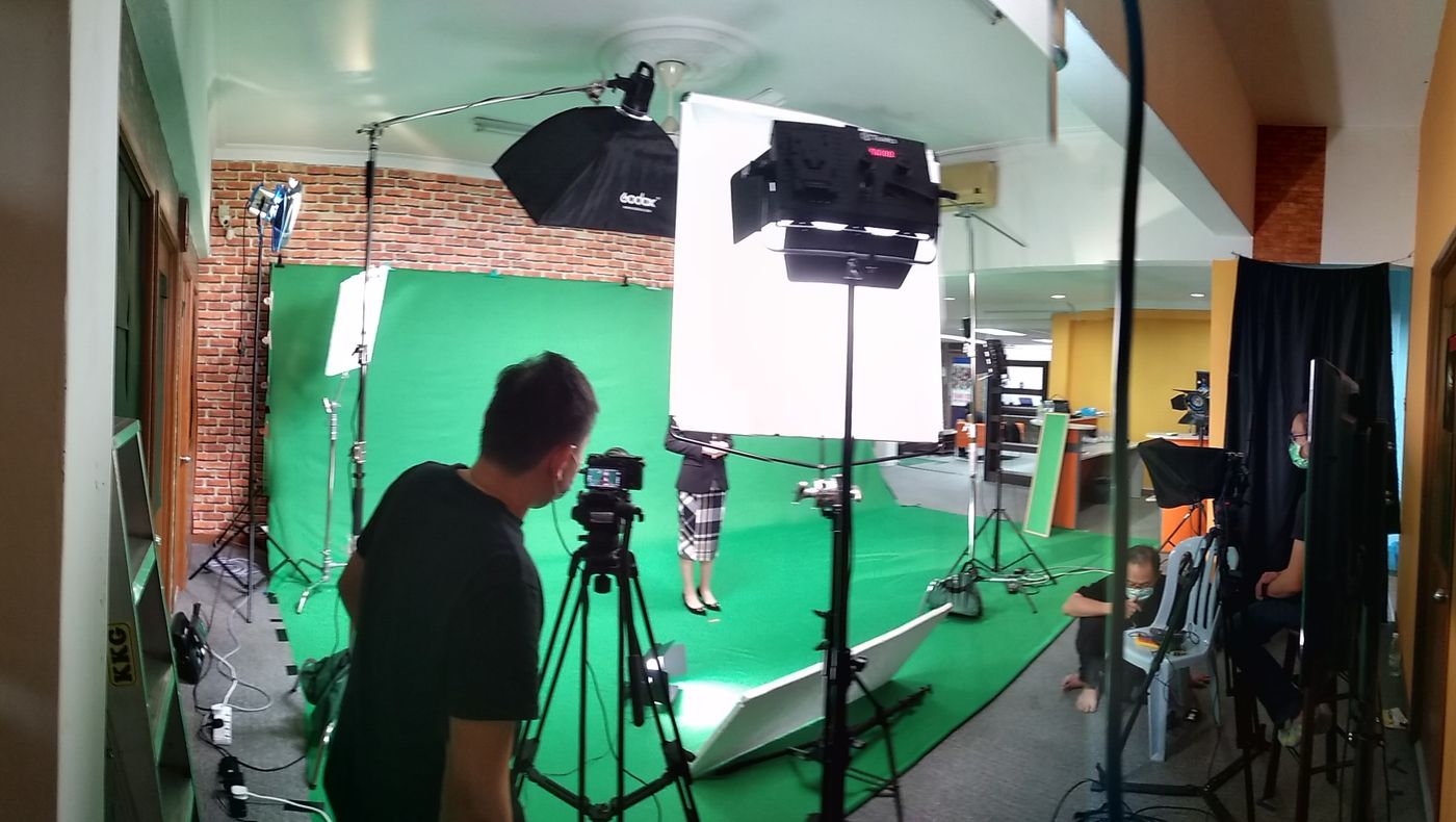 Green screen studio with lighting and cameras set up for video production in Kuala Lumpur