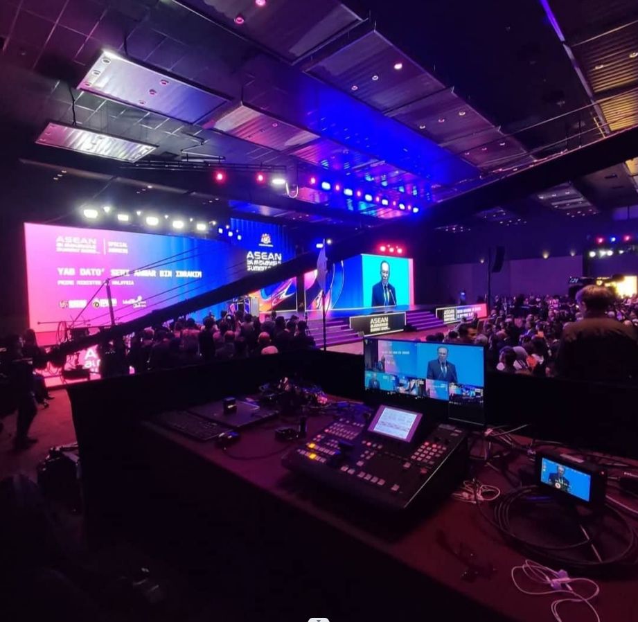Livefeed switcher desk facing the stage and LED screens at a summit in Kuala Lumpur